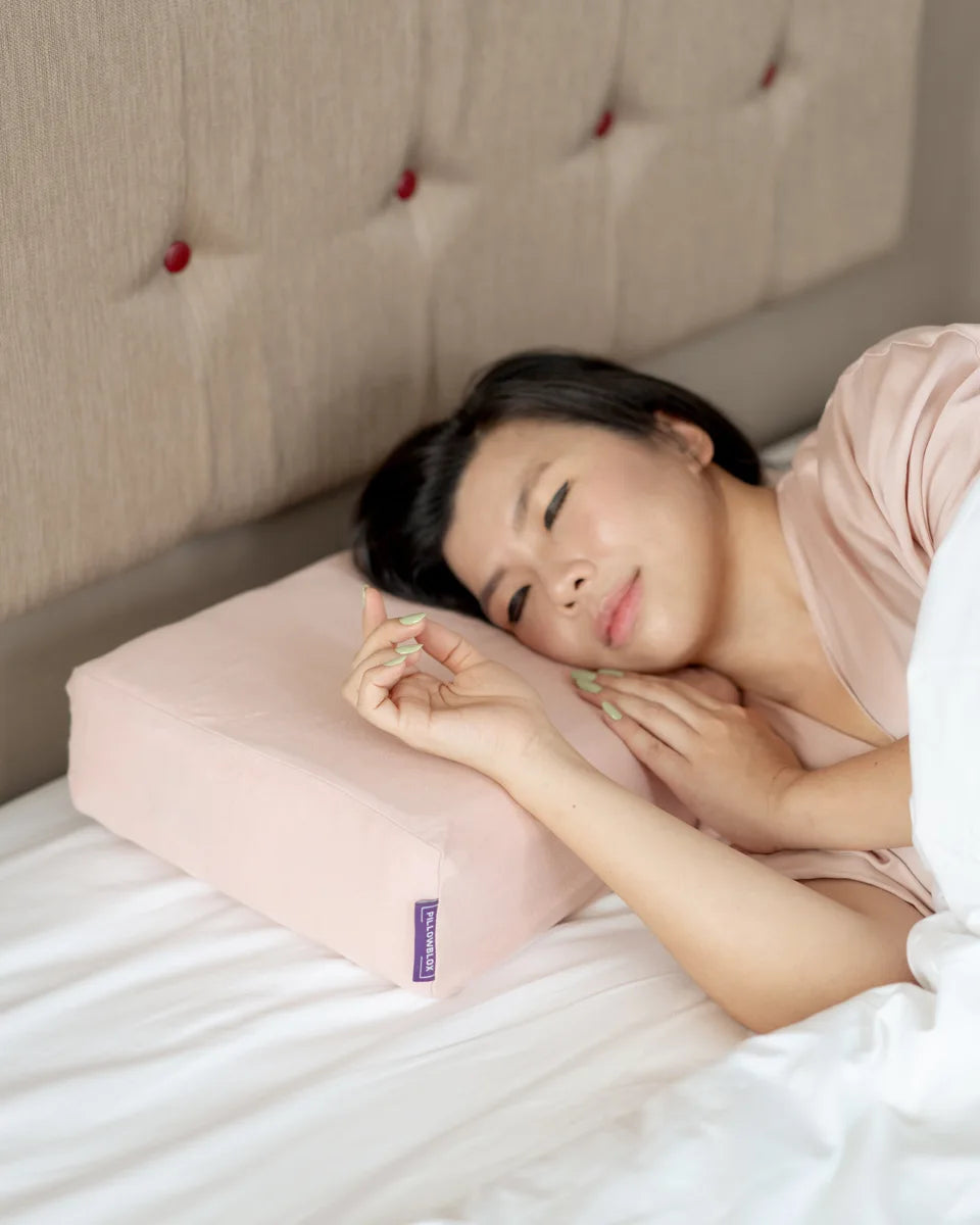 A woman sleeping on her side with a Pillowblox pillow
